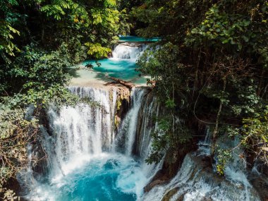 Scenic cascade waterfall with natural blue water in Central Sulawesi, drone view clipart