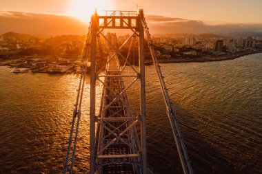 Aerial view of city and cable stayed bridge with bright sunset in Florianopolis, Brazil clipart