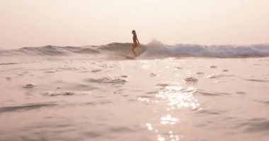 Mavi okyanus dalgasında sörf tahtasında sörf yapan kadın. Sörf tahtasında sörf yapan kız. Yüksek kalite 4k görüntü