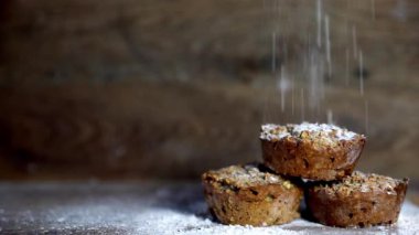 Fresh muffins banana with wooden background shallow focus with falling flour and copy space. healthy bread banana cupcakes