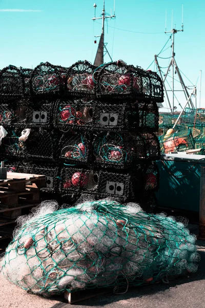 Fishing nets stacked on the pier in a harbour, close-up background fisherman net and boat work