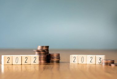 difference coin stack savings in year 2022 and 2023. Economy recession crisis, inflation, stagflation, business and financial loss concept. copy space savings