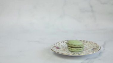 Colorful macarons. Close up of multicolor macarons , french macaroon, greedy pastry. French dessert sweets colored macaroons cookies arranged timelapse on white background