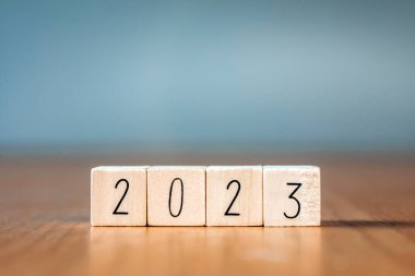 2023 New Year. wooden blocks 2023 on blue background. Start new year 2023 with goal plan, goal concept, action plan, strategy, new year business vision. copy space close up