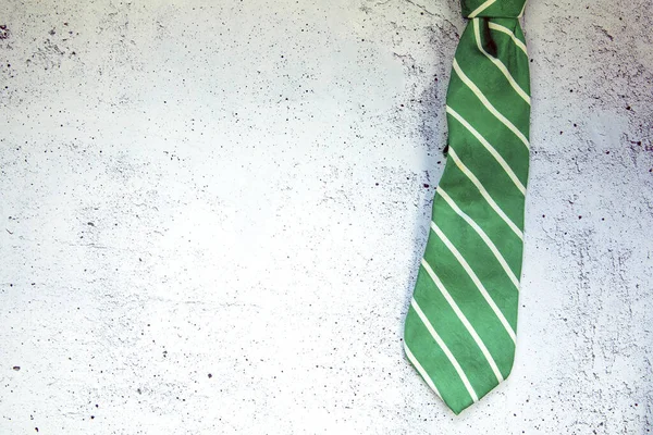 Stylish Tied Green Striped Tie Concrete White Background Top View — Fotografia de Stock