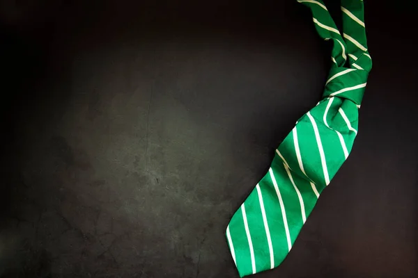 Stylish Tied Green Striped Tie Dark Concrete Background Top View — Fotografia de Stock