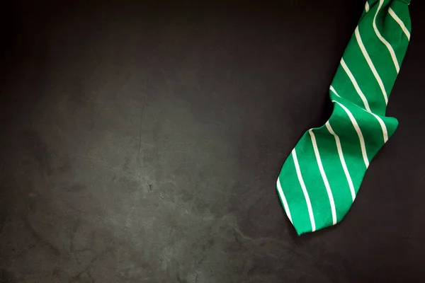 Stylish Tied Green Striped Tie Dark Concrete Background Top View — Fotografia de Stock