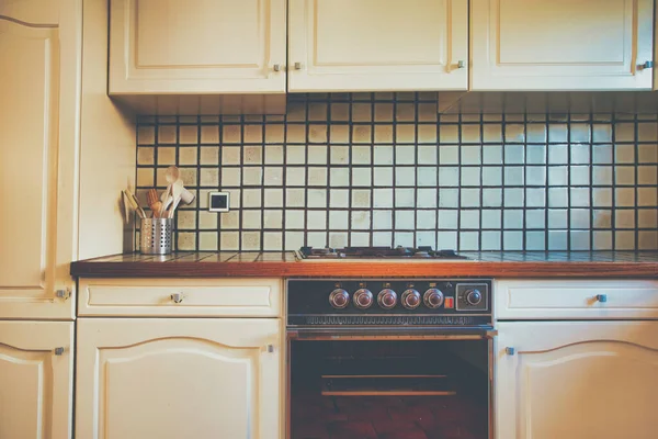 Vintage retro kitchen with green pattern tiles, american retro kitchen home interior design 70's 80's style close-up. retro background