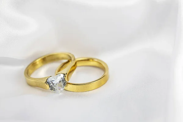 Festive Wedding Background Two Gold Rings Diamond White Satin Material — Stock Photo, Image