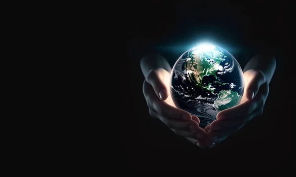 Hands holding earth.Earth in your hands, Saving Earth concept, Hands holding Earth with a black background. Human hands holding global copy space space for text