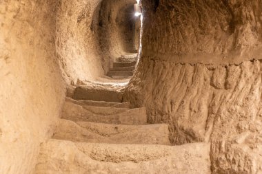 Stone tunnel and staircase drilled in the rock in Vardzia cave monastery complex in Georgia, inside view of underground medieval city.