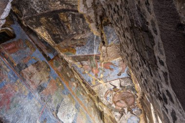 Church of Dormition with colorful medieval frescos in Vardzia cave monastery complex, Georgia. Inside view of stone chapel.