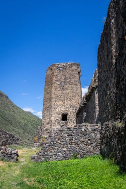 Khertvisi Fortress lower courtyard in Georgia, stone medieval castle wall with watchtowers and citadel on a green rocky hill in Lesser Caucasus mountains in Samtskhe - Javakheti (Meskheti) region.