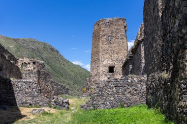 Khertvisi Fortress lower courtyard in Georgia, stone medieval castle wall with watchtowers and citadel on a green rocky hill in Lesser Caucasus mountains in Samtskhe - Javakheti (Meskheti) region.