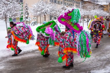 Milowka, Poland, 21.01.2023. Gody Zywieckie - traditional winter parade of 'Dziady', folk custom in Zywiec region, men dressed in traditional horse costumes, dancing and caroling on the street.