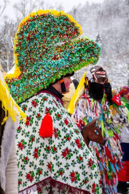 Milowka, Poland, 21.01.2023. Gody Zywieckie - traditional winter parade of 'Dziady', folk custom in Zywiec region, man dressed in traditional colorful costume of horse with large hat.