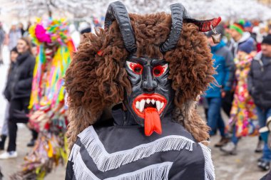 Milowka, Poland, 21.01.2023. Gody Zywieckie - traditional winter parade of 'Dziady', 'Jukace', folk custom in Zywiec region, man dressed in traditional costume of devil.