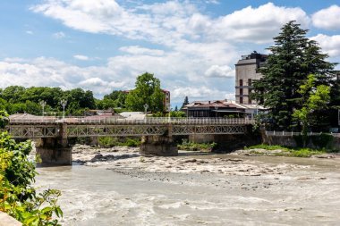 White Bridge, historical metal pedestrian bridge in old part of Kutaisi, Georgia, with river Rioni below and famous white rocks.