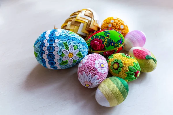 stock image Colorful Easter eggs with floral ornaments, origami decorations and crewel wool against white background, different techniques of Easter eggs decoration, Poland.