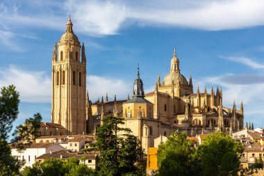 Segovia Katedrali Orta Çağ Gotik binası, zengin dekore edilmiş kuleleri, yeşil ağaçlar arasında, yaz, İspanya.