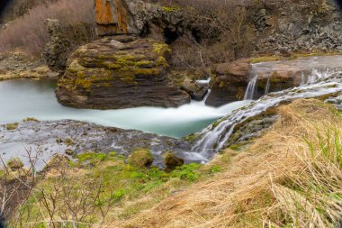 Gjain Canyon landscape with small waterfalls and lush vegetation, Thjorsardalur  valley, Iceland, long exposure. clipart