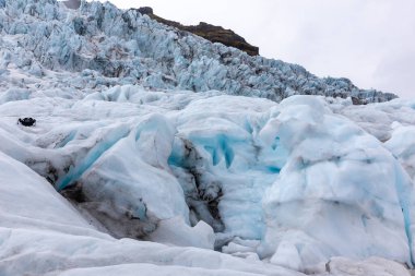 Skaftafell Glacier landscape, part of Vatnajokull National Park, Iceland. Blue glacier ice with cracks and crevasses and ice formations.