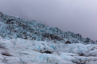 Skaftafell Glacier landscape, part of Vatnajokull National Park, Iceland. Blue glacier ice with cracks and crevasses. clipart