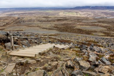 Wooden staircase to Borgarvirki columnar basalt Viking fortress with landscape of Vatnsnes peninsula in northwest Iceland. clipart