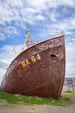 Rusty steel hull of Gardar BA 64 shipwreck, old whaling and fishing vessel, resting on the shoreline of Patreksfjordur, Westfjords, Iceland. clipart