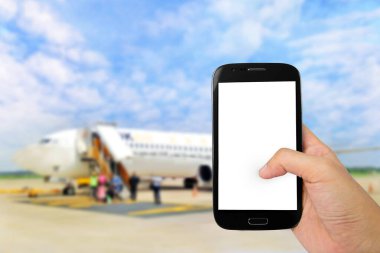 Mans hand holding smartphone , Transportation integration concept , Mobile Boarding Passes concept with airport abstract background , copyspace area