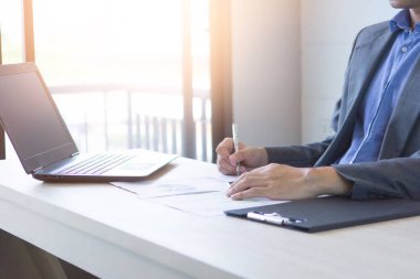 Business documents with notebook or labtop and graph business diagram.new startup project. attached to target on graph business diagram on desk. Business and success concept