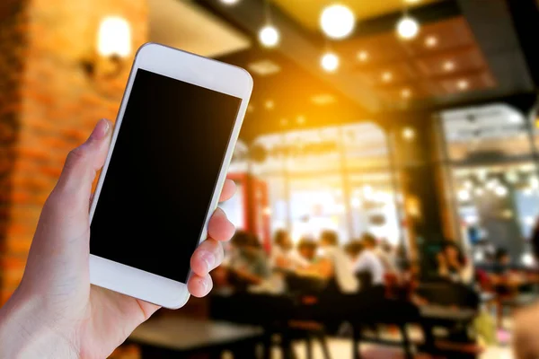 Woman Hand Holding Smartphone Coffee Shop Blur Background Bokeh Light — Fotografia de Stock