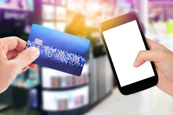 Woman Hand Holding Smart Phone Credit Card Blurred Cosmetic Shop — Fotografia de Stock