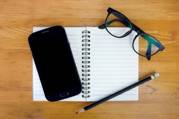 Smartphone Calculator Notepad Glasses Pencil Wooden Background Top View —  Fotos de Stock