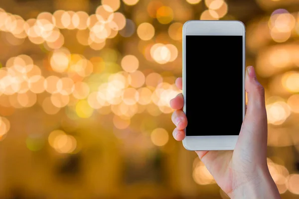 Woman Hand Holding Empty Screen Smart Phone Blur Festive Gold — Fotografia de Stock