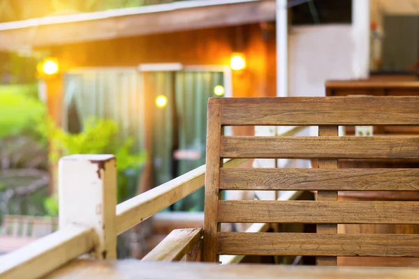 Wood chair in natural resort with sunshine and soft blur background.