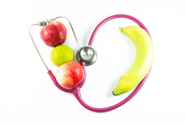 stethoscope , apples , orange and banana on the white background