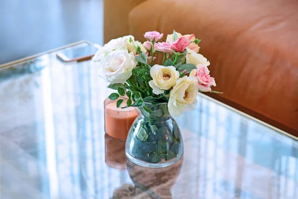Rose flower on a table in a vase.