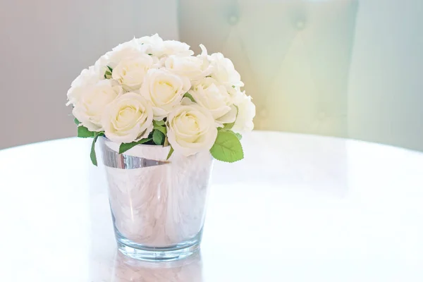 Bouquet of white rose in glass vase near the window.(soft tone)