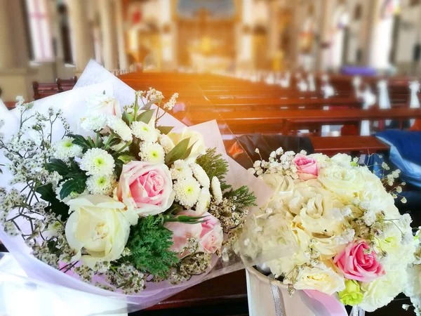 beautiful bouquet with church wedding and sunshine background
