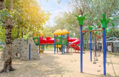 colorfull of play ground big plastic toy set for children or garden park playground, playground on day noon light with sunshine in city park.