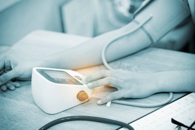 Checking blood pressure - close up(blue tone)