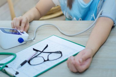 Checking blood pressure by yourself.(blue tone)