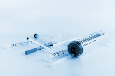 Blue tone of image of mixs of medical ampoules and syringe.