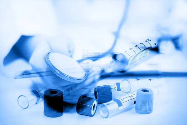 Double exposure of close up of Test-tubes ,stethoscope and medical equipment on a light blue background