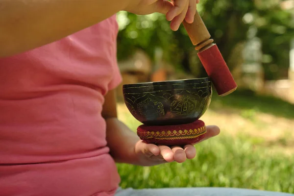 close-up of a little girl with a Tibetan bowl in her hands
