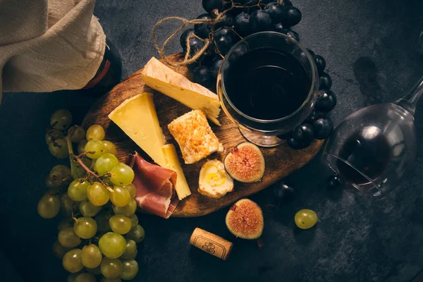 stock image still life bottle wine couple glasses different cheeses and fruits grapes figs and pomegranate