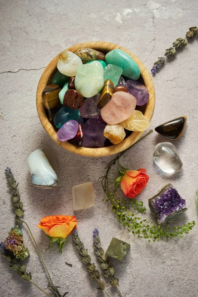 various gem stones in a wooden bowl top view