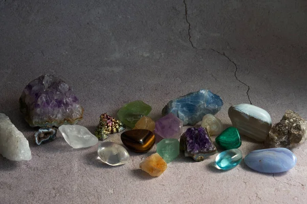 various gem stones on a concrete gray background