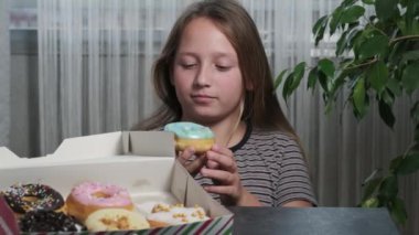 blonde girl holds donust near her face